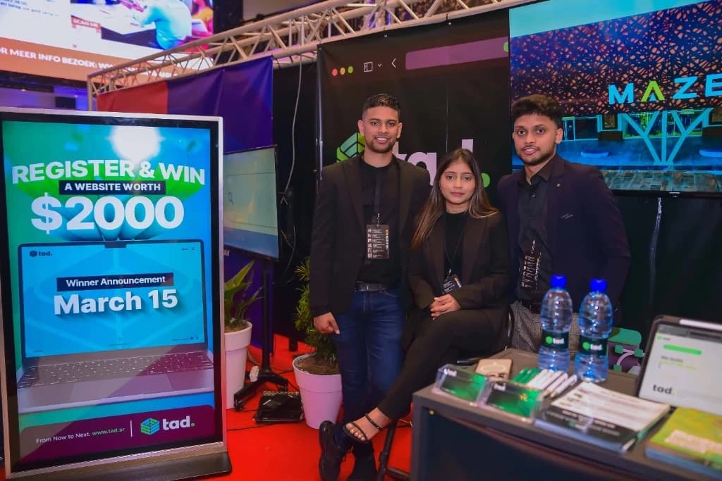 The TAD team at a trade show booth in Paramaribo